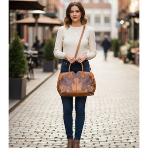 handmade caramel and brown leather tote bag with dark brown rose embellishments.